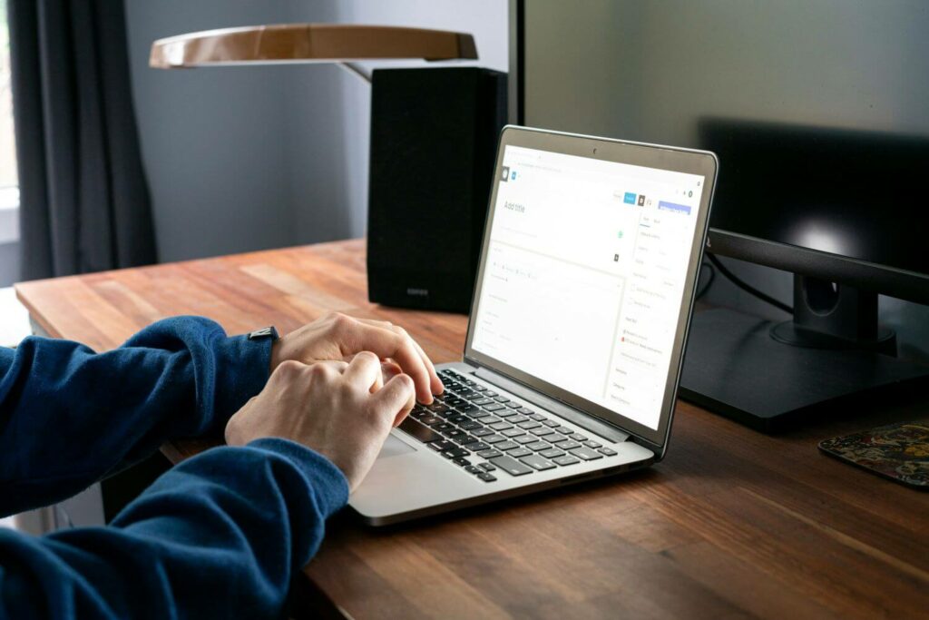 student writing their PhD thesis introduction on laptop